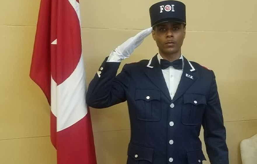 FOI Bro. Taseanby Karriem posing near Nation of Islam flag