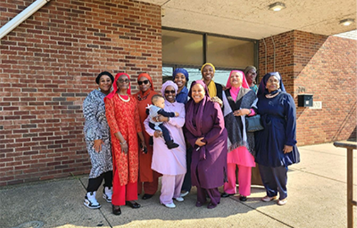 MGT of Muhammad Mosque 102 in Chester, Pa standing in front of Mosque building